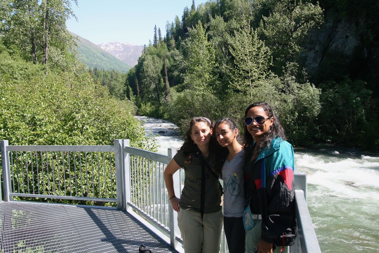 Students posing near a river